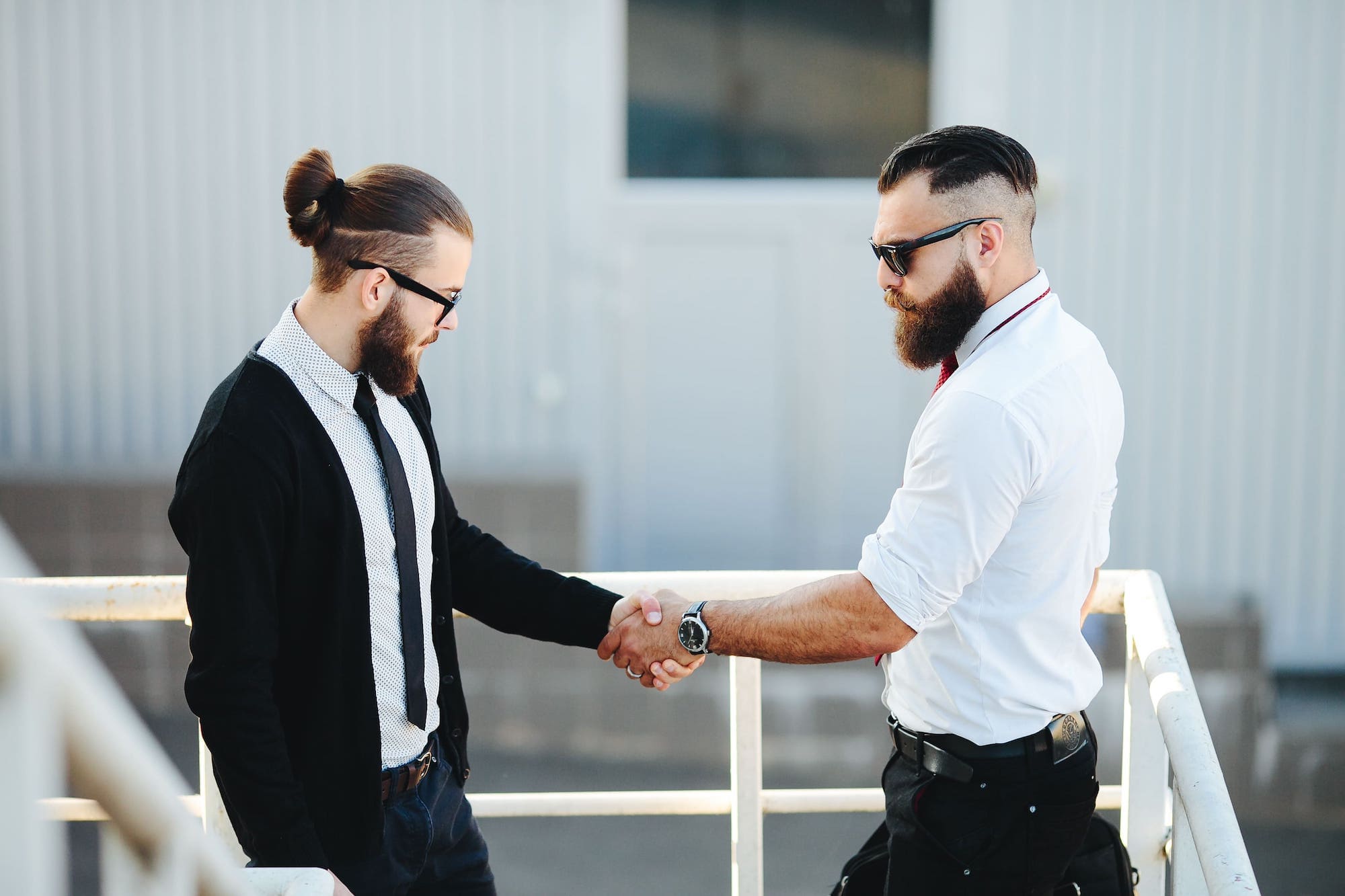 Dos hombres de negocios dándose la mano, representando ser autónomo y asalariado al mismo tiempo.