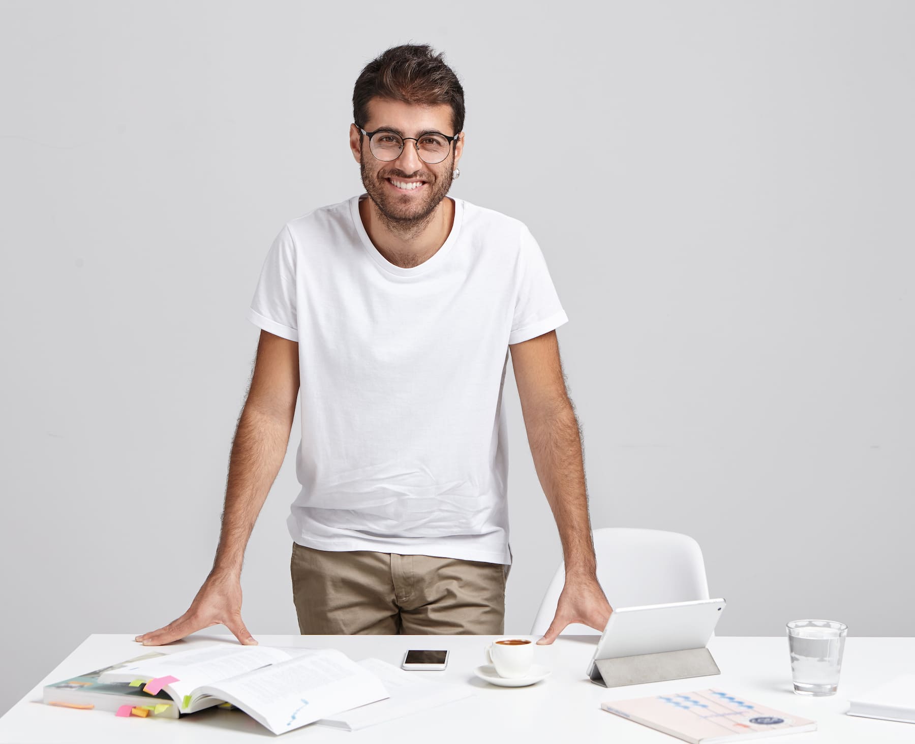 Hombre sonriente junto a documentos y tablet, simbolizando cómo interpretar correctamente la factura de la luz.